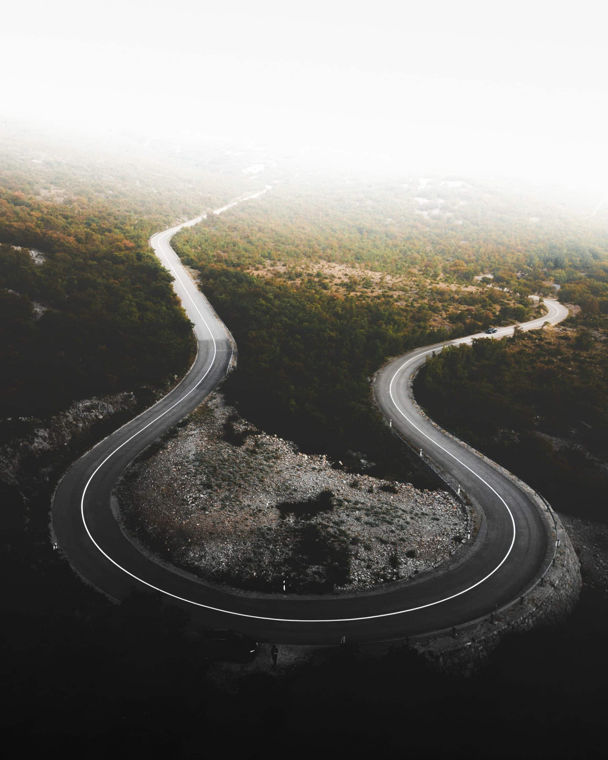 Aerial view of a winding mountain road, symbolising the therapeutic journey through life's challenges